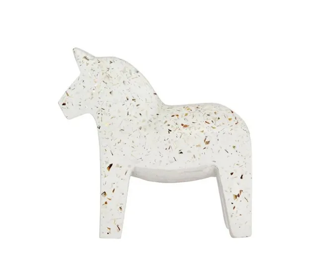 White horse-shaped figurine with speckled terrazzo pattern against a plain background.
