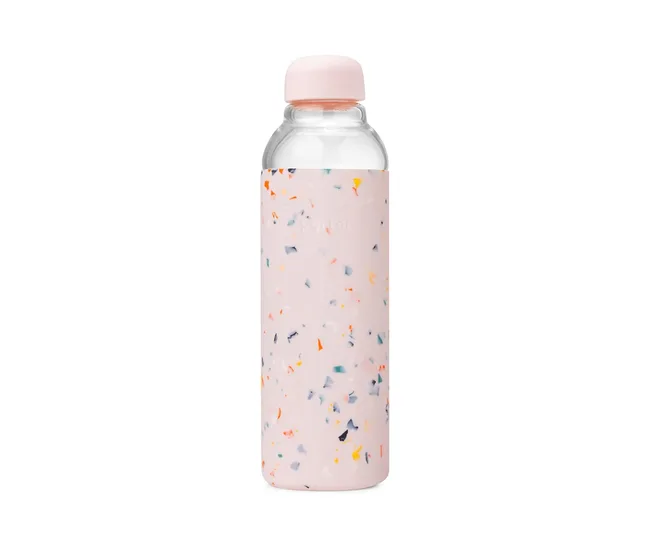 Pink glass water bottle with a terrazzo pattern silicone sleeve.