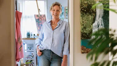 Tracey Finch standing in front of her art studio