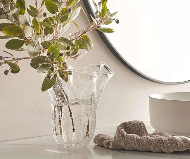 A clear vase with branches