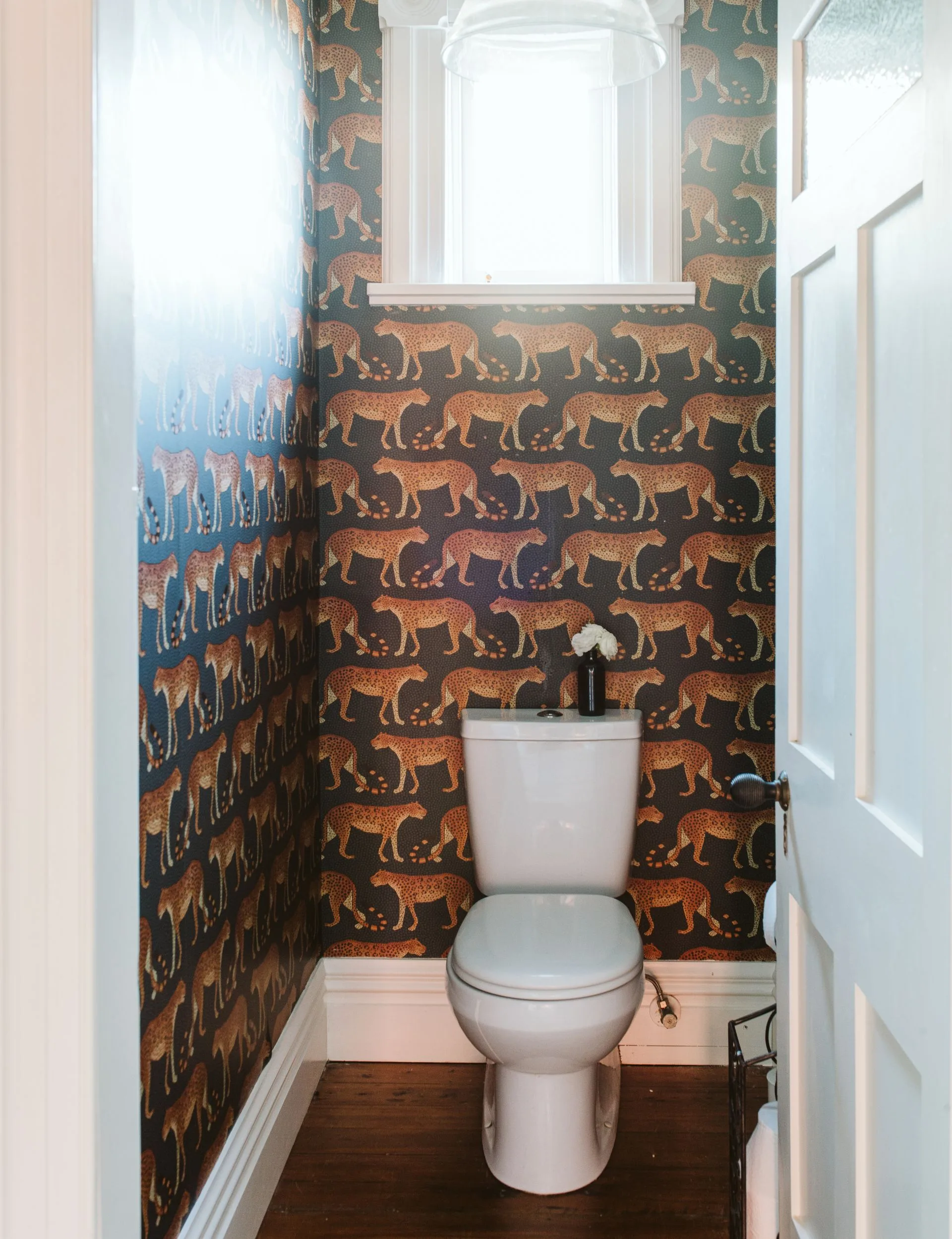 The powder room of the New Plymouth villa with cheetahs all over the wallpaper