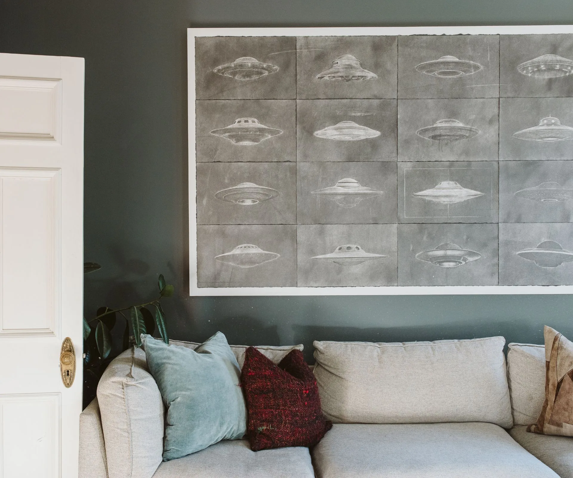 A UFO art work hanging above the couch in the New Plymouth villa