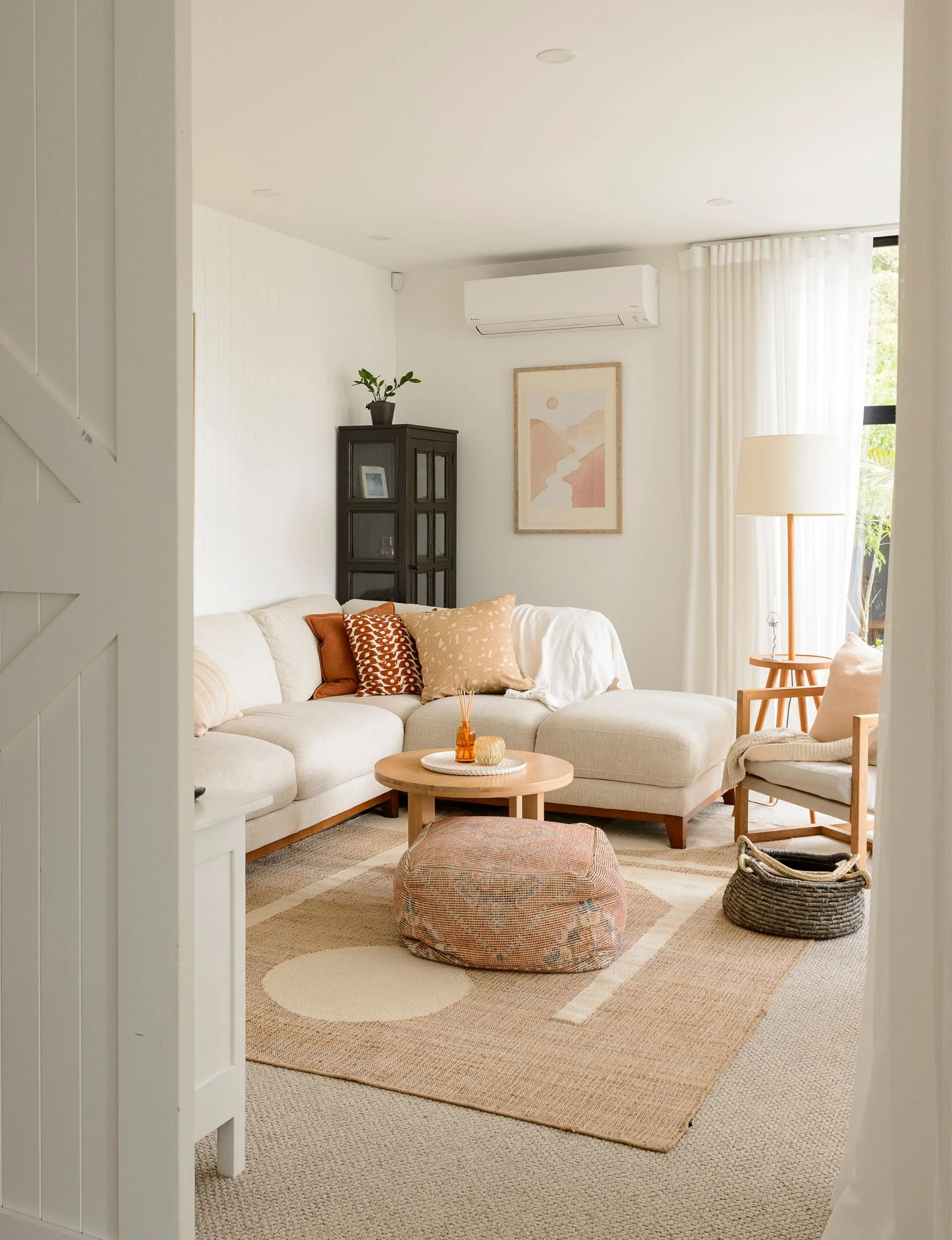 The Pakuranga new-build living room with the big white barn door cracked open