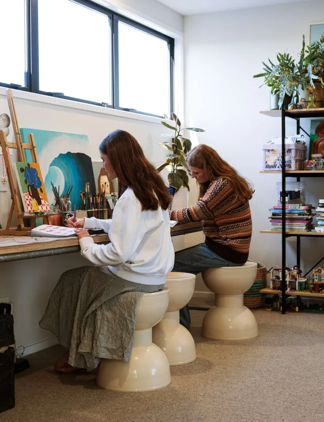 Two teenage girls drawing in their art studio in their Mount Maunganui bungalow