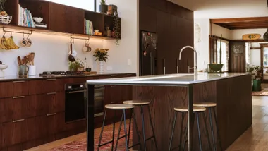 The kitchen of the Mount Maunganui bungalow with walnut cabinets