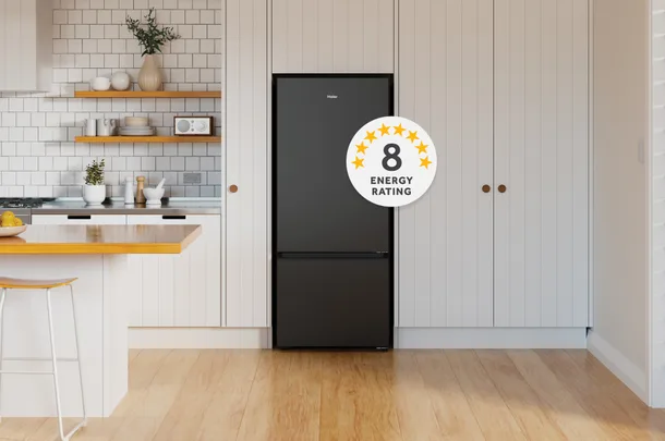 Black refrigerator in a modern kitchen with white cabinets. An 8-star energy rating badge is displayed.