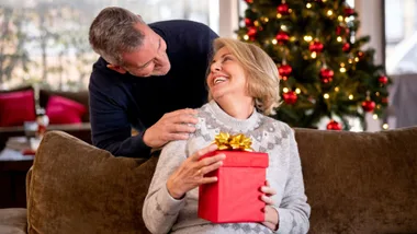 A man giving his wife a Christmas gift