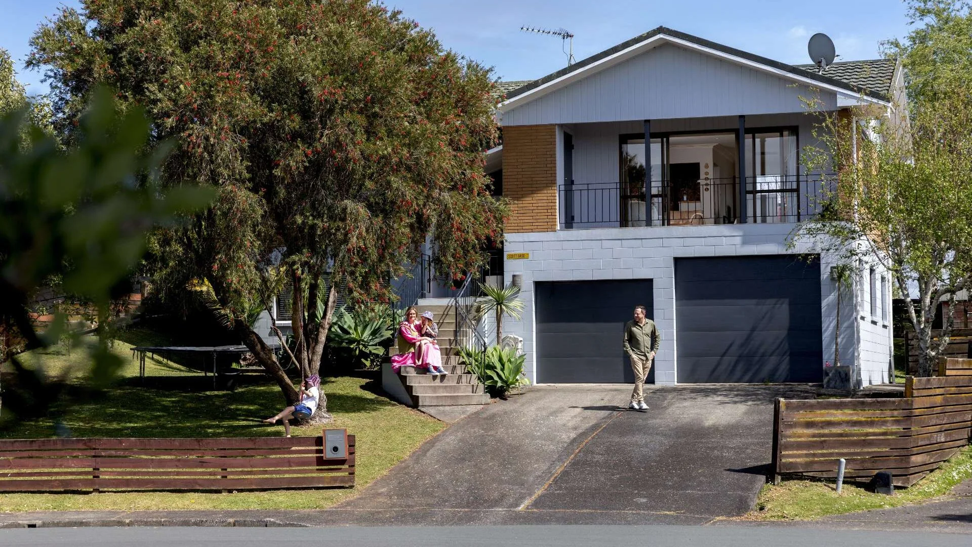 The family playing outside the Whangaparāoa home