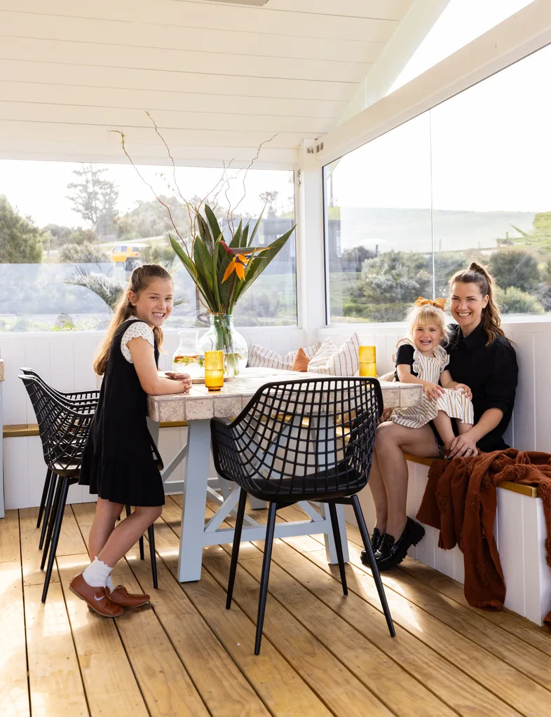 Alice Pearson with two of her children on the outdoor deck