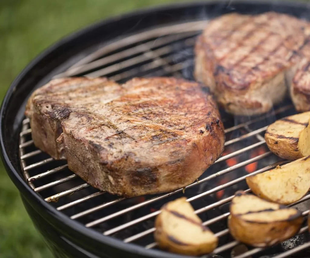 Steaks grilling on the Weber barbecue
