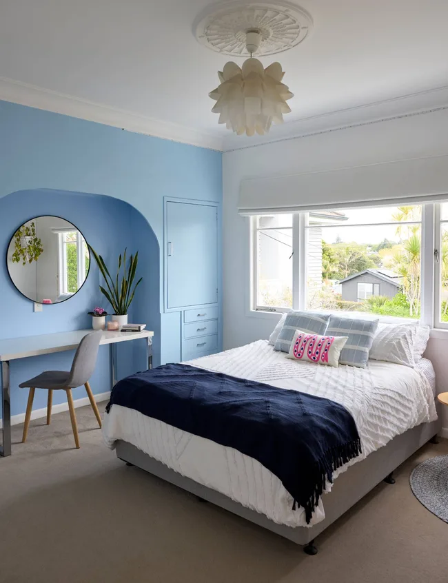 A blue-themed bedroom with a double bed