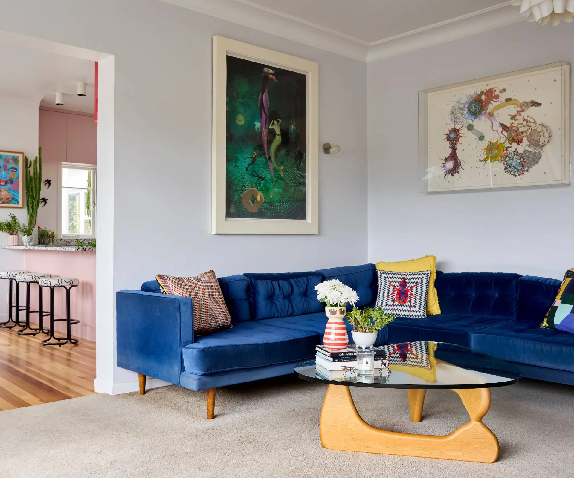 The living room of the Auckland art deco home with a bright blue couch