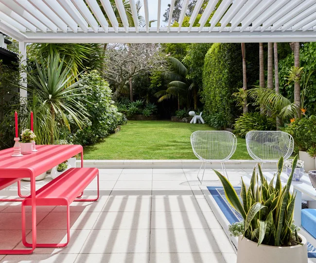 The outdoor living space opening up to the lawn