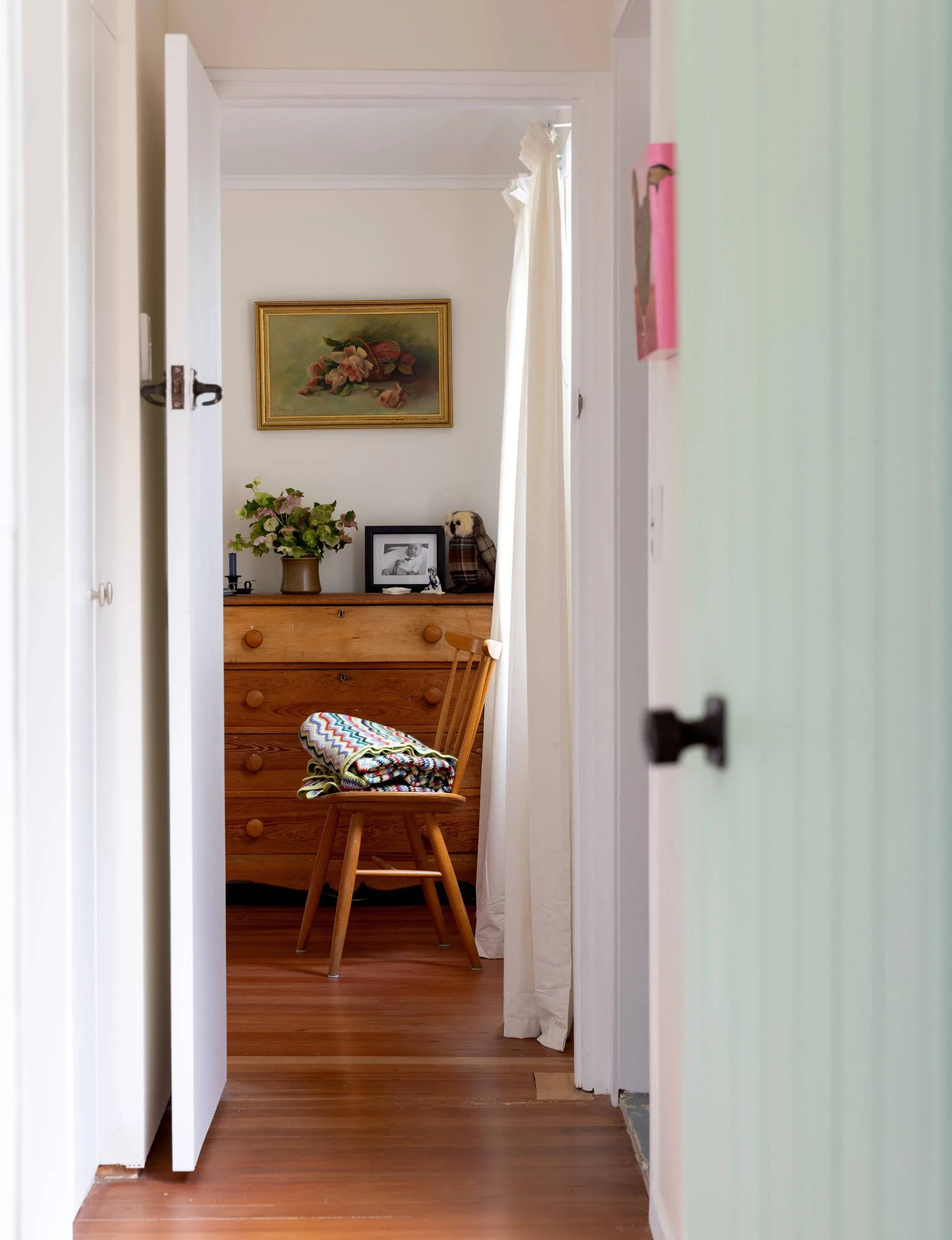 A sea foam green door that leads to hallway through the Point Wells bach