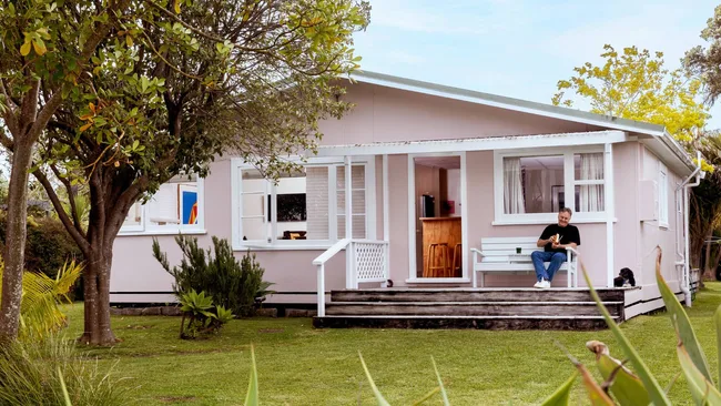 The exterior of the pastel pink Point Wells bach