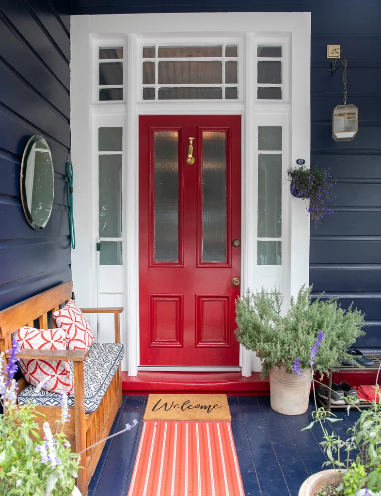 Red front door and blue painted outdoor landing