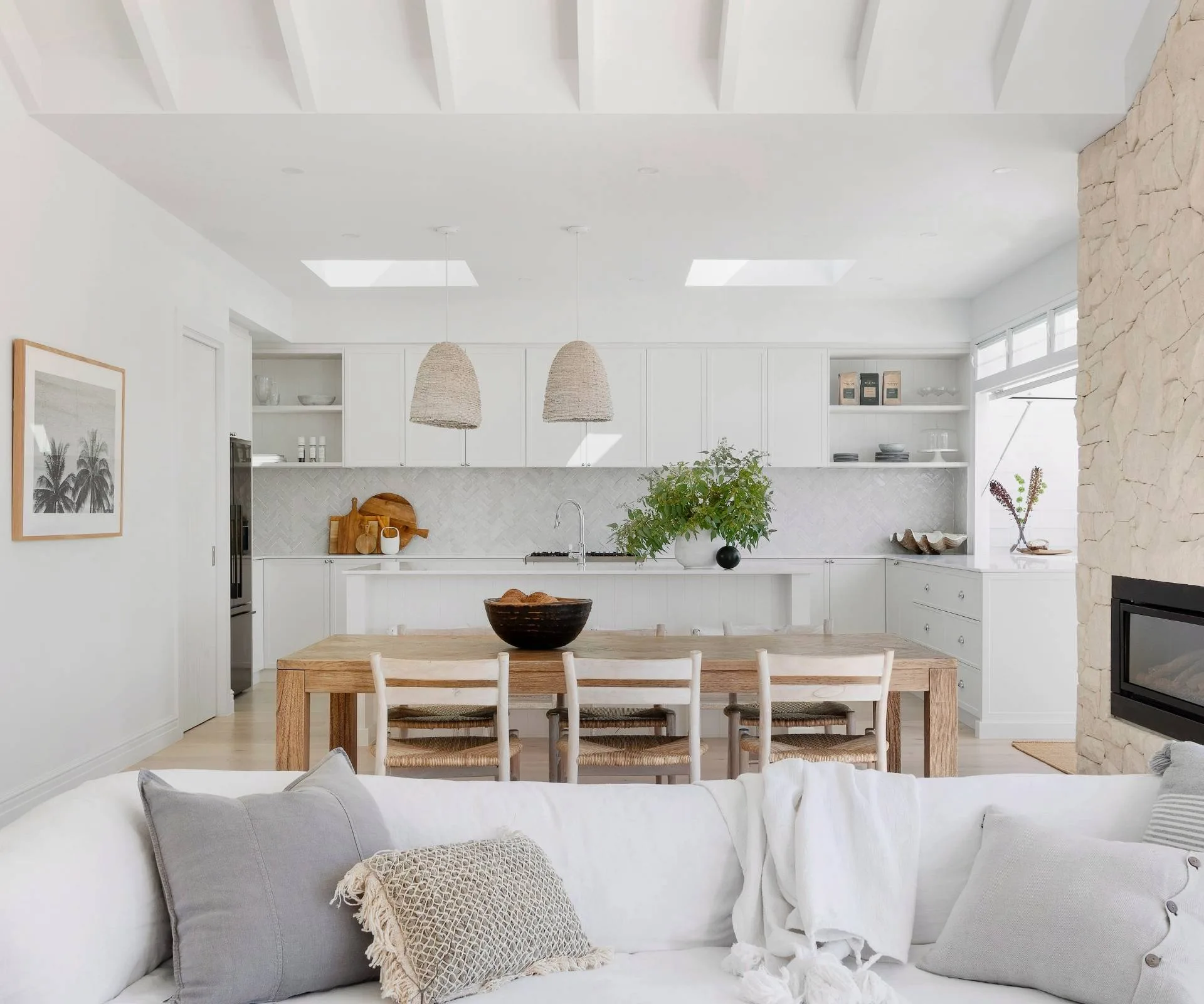 The Hamptons-style home kitchen viewed from over the white couch