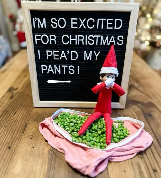 Elf on the shelf with a black board behind