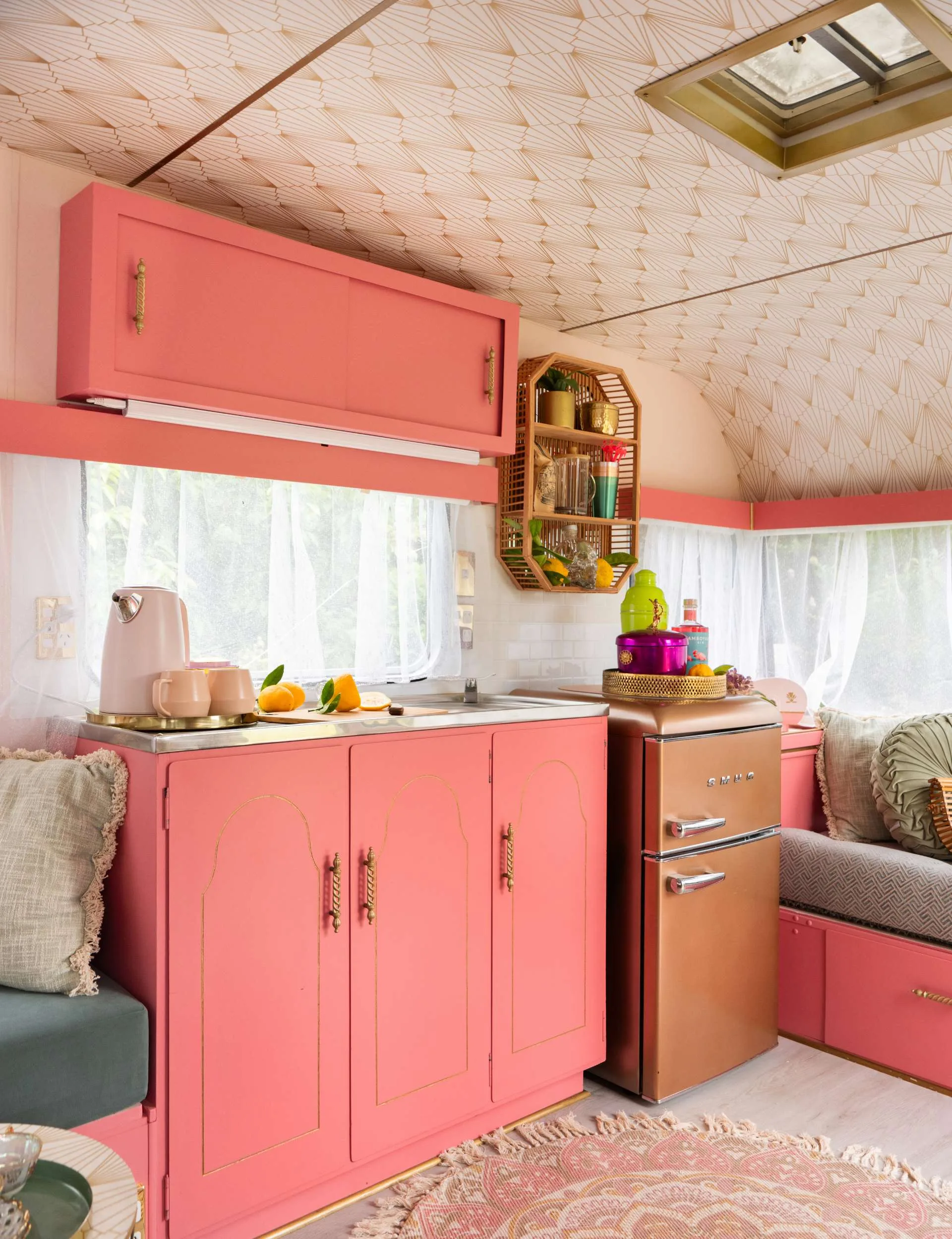 Pink kitchen with a gold fridge