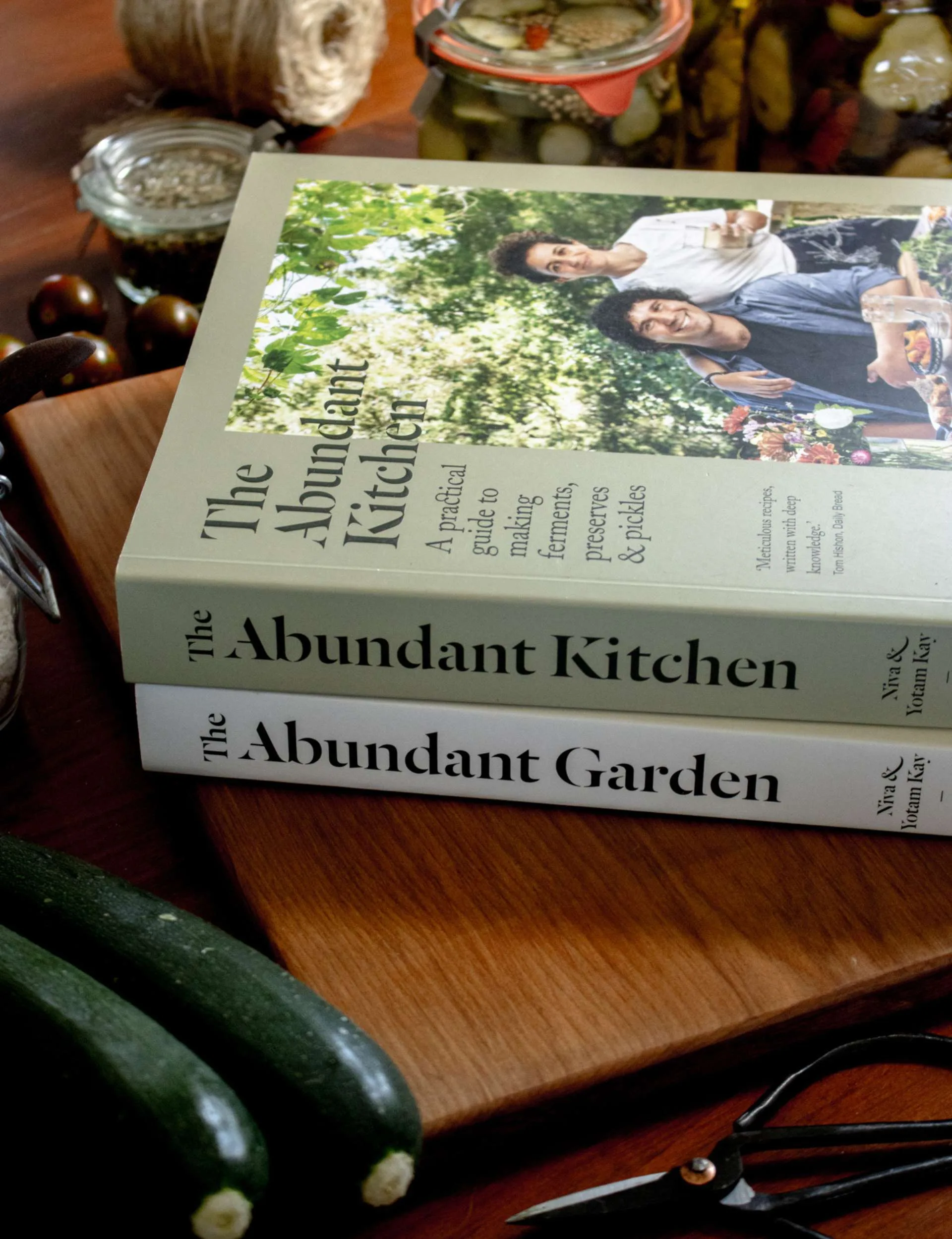 Two books stacked on top of each other. The Abundant Kitchen book ontop of The Abundant Garden book.
