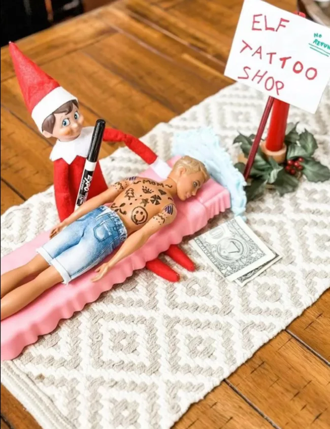 Elf on the Shelf tattooing ken's back