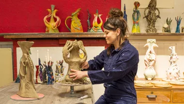 Lucy Hunter working clay into a vase