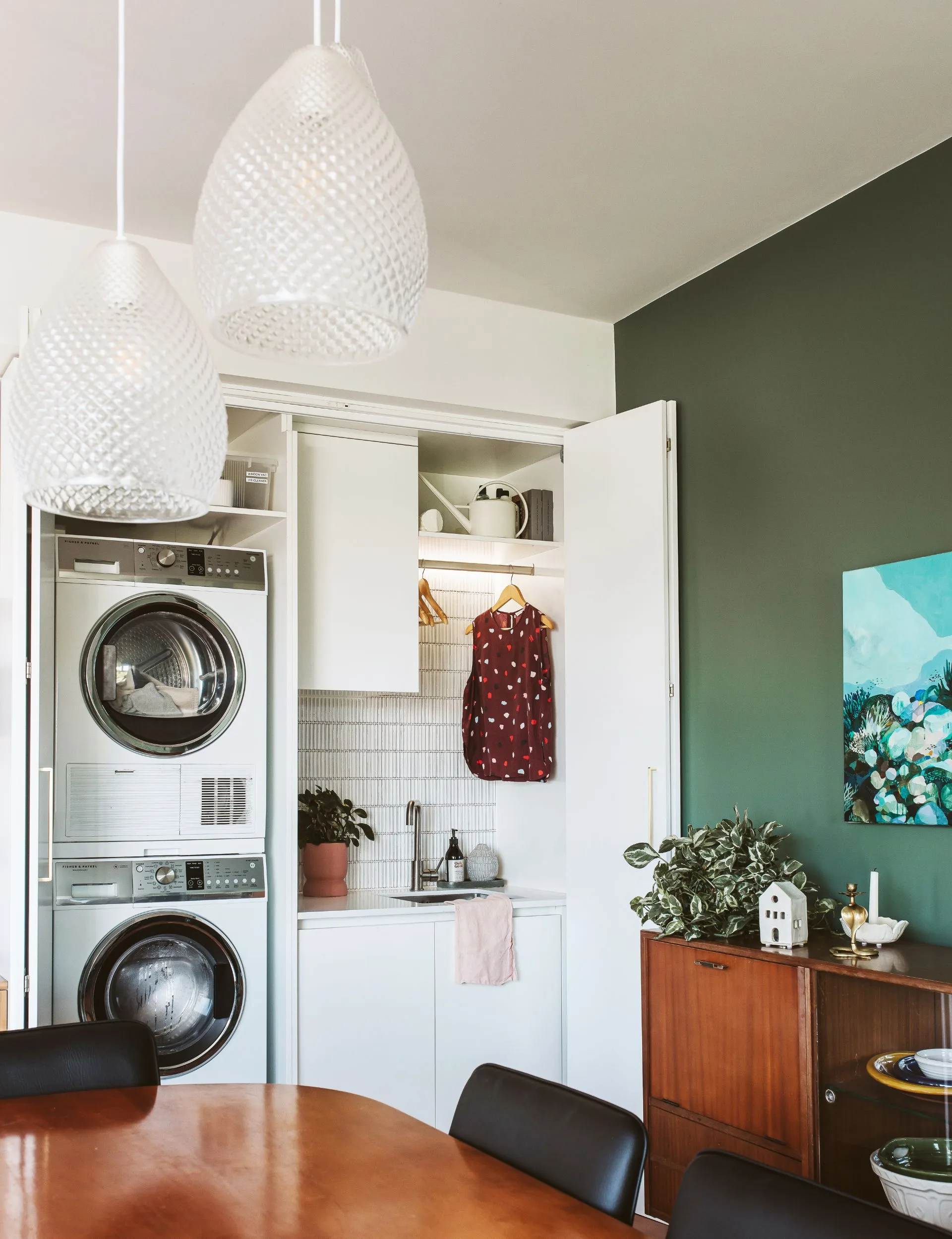 The renovated New Plymouth villa has a laundry cupboard hidden behind the dining room table