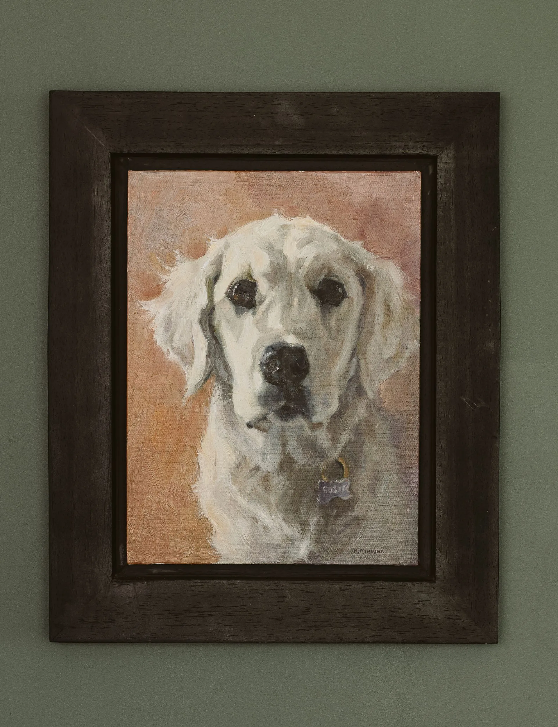 A panting of a golden retriever dog in a black frame on a green wall