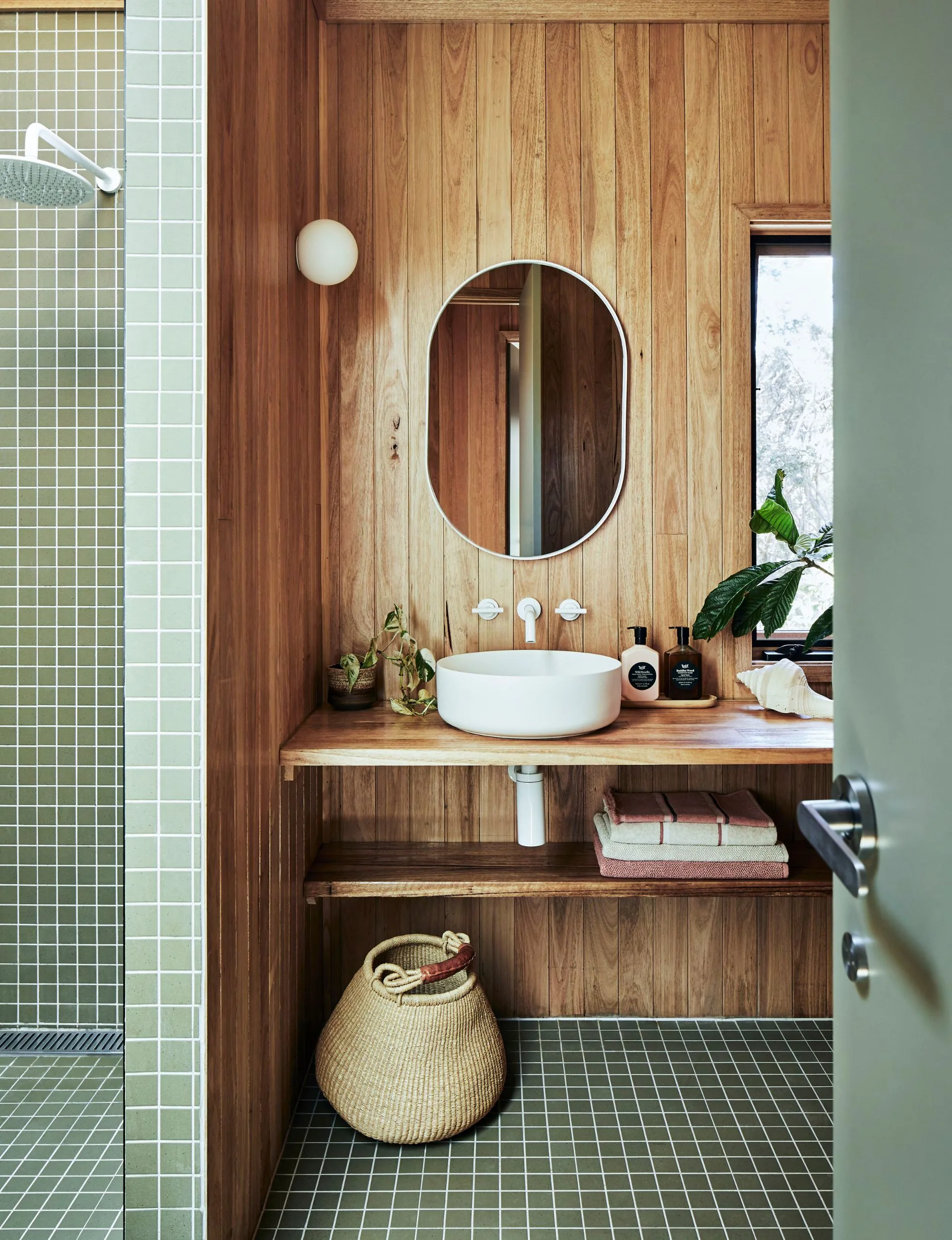 Mint green tiles in the renovated beach cabin bathroom