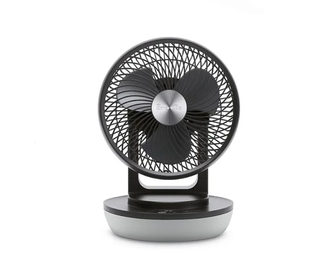 Grey and black tabletop portable fan against a white background