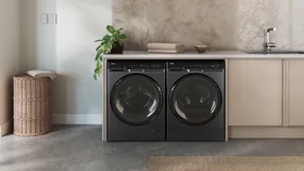 The Haier Front Load Washer and Heat Pump Dryer in laundry room