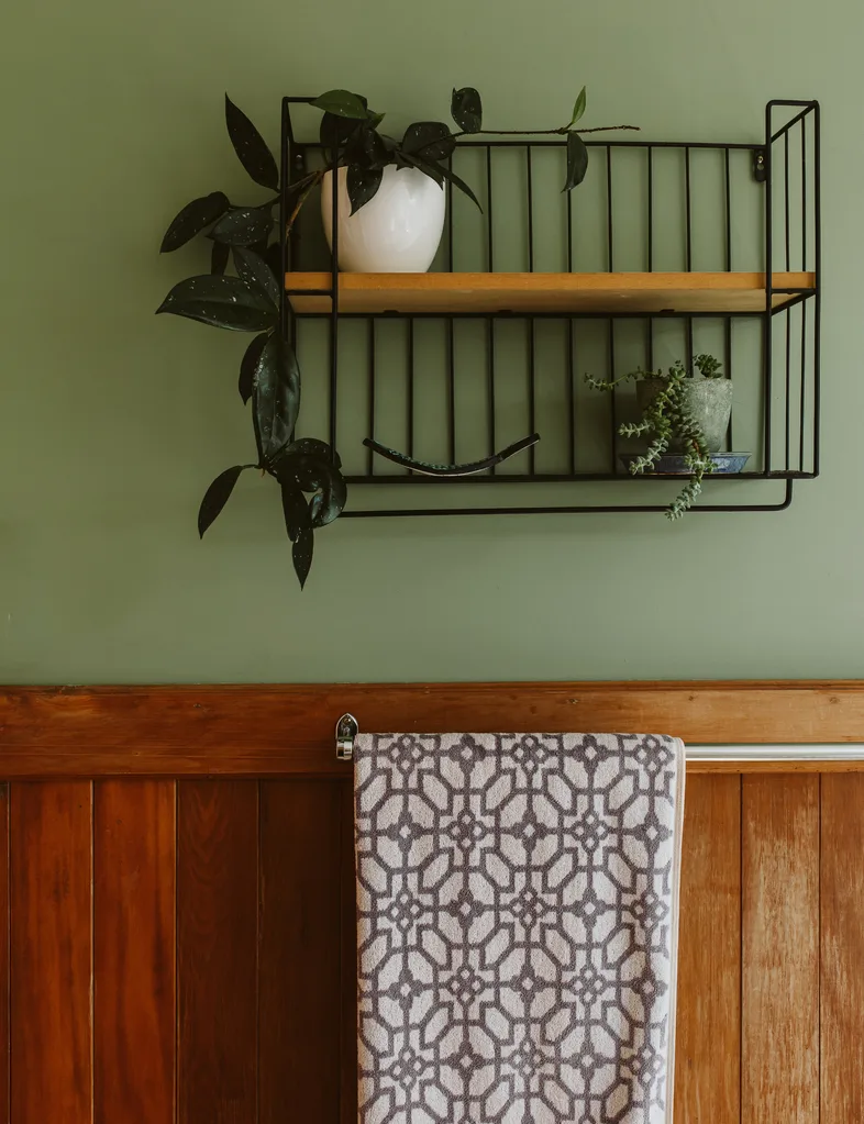 Resene Wabi Sabi, a green paint shade, is used to refresh bathroom wall