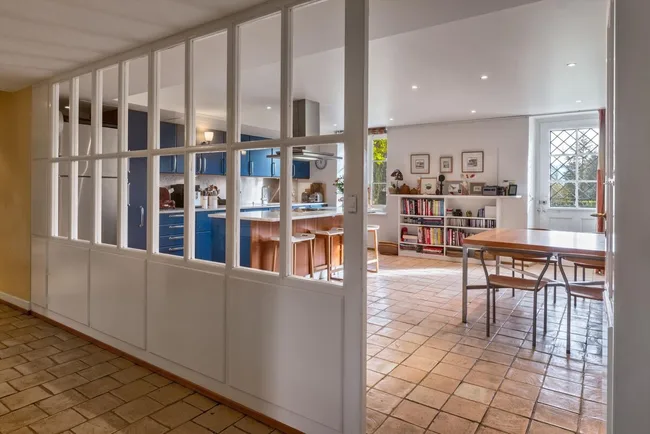 The blue kitchen seen from the glass separating doors