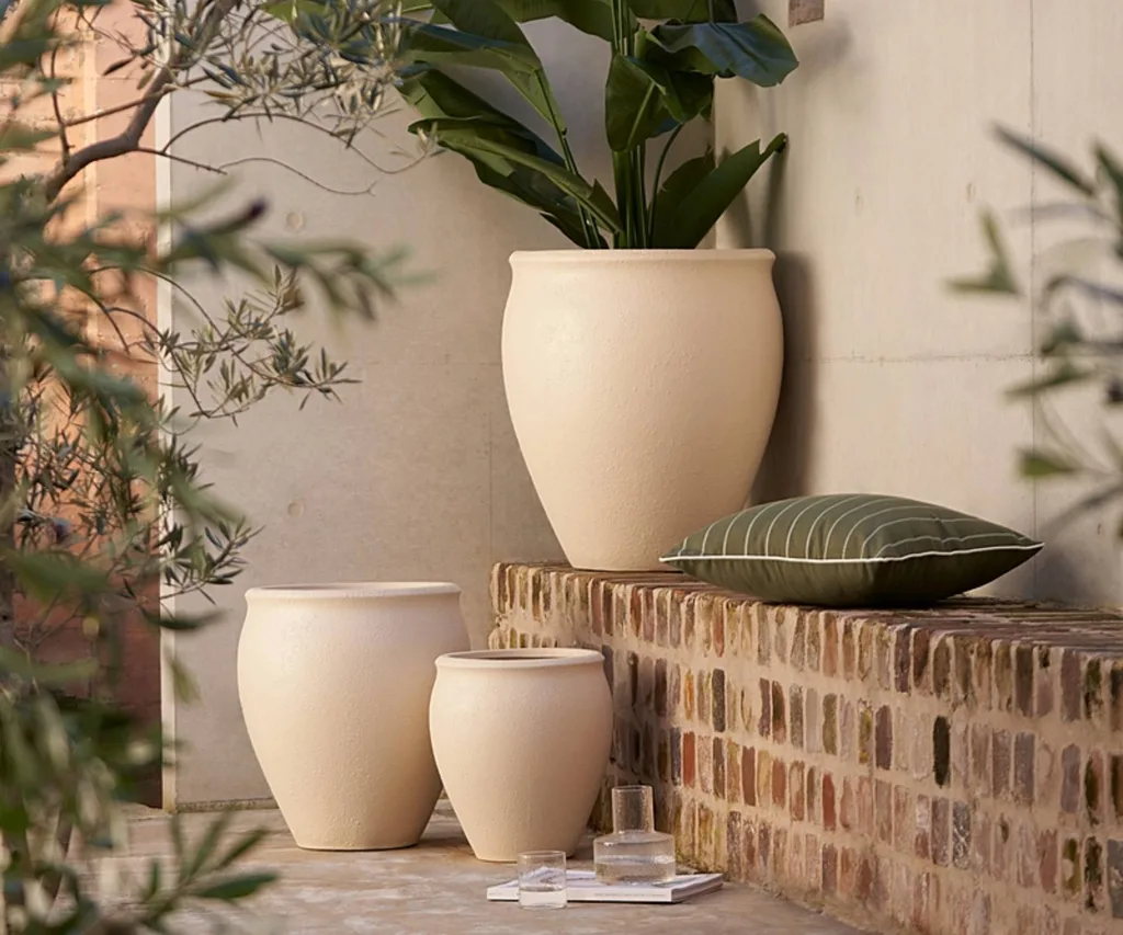 Three beige coloured pots in an outdoor setting