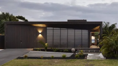 A dark timber house just off the beach