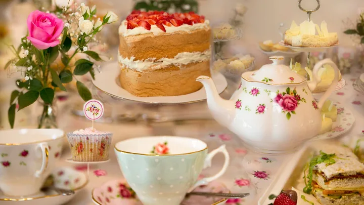 A high tea event with cake, a teapot and a cup