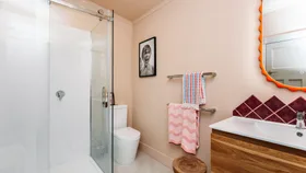 Colour drenched bathroom using Resene Just Right, a brown-toned pastel pink