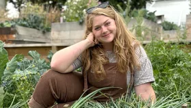 Poppy Prendergast sitting in her garden