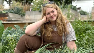 Poppy Prendergast sitting in her garden
