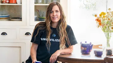 Reb Fountain sitting at her dining room table