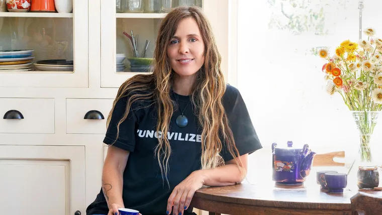 Reb Fountain sitting at her dining room table