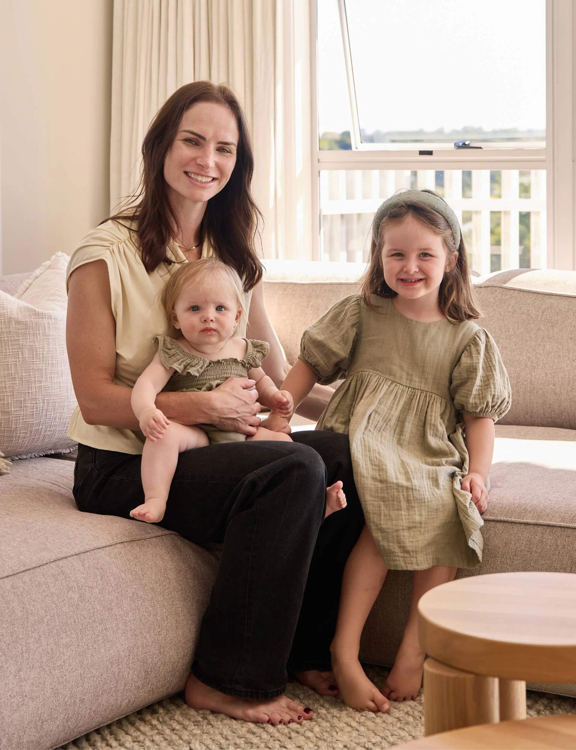 70s home owner Sian with her daughters on the living room couch