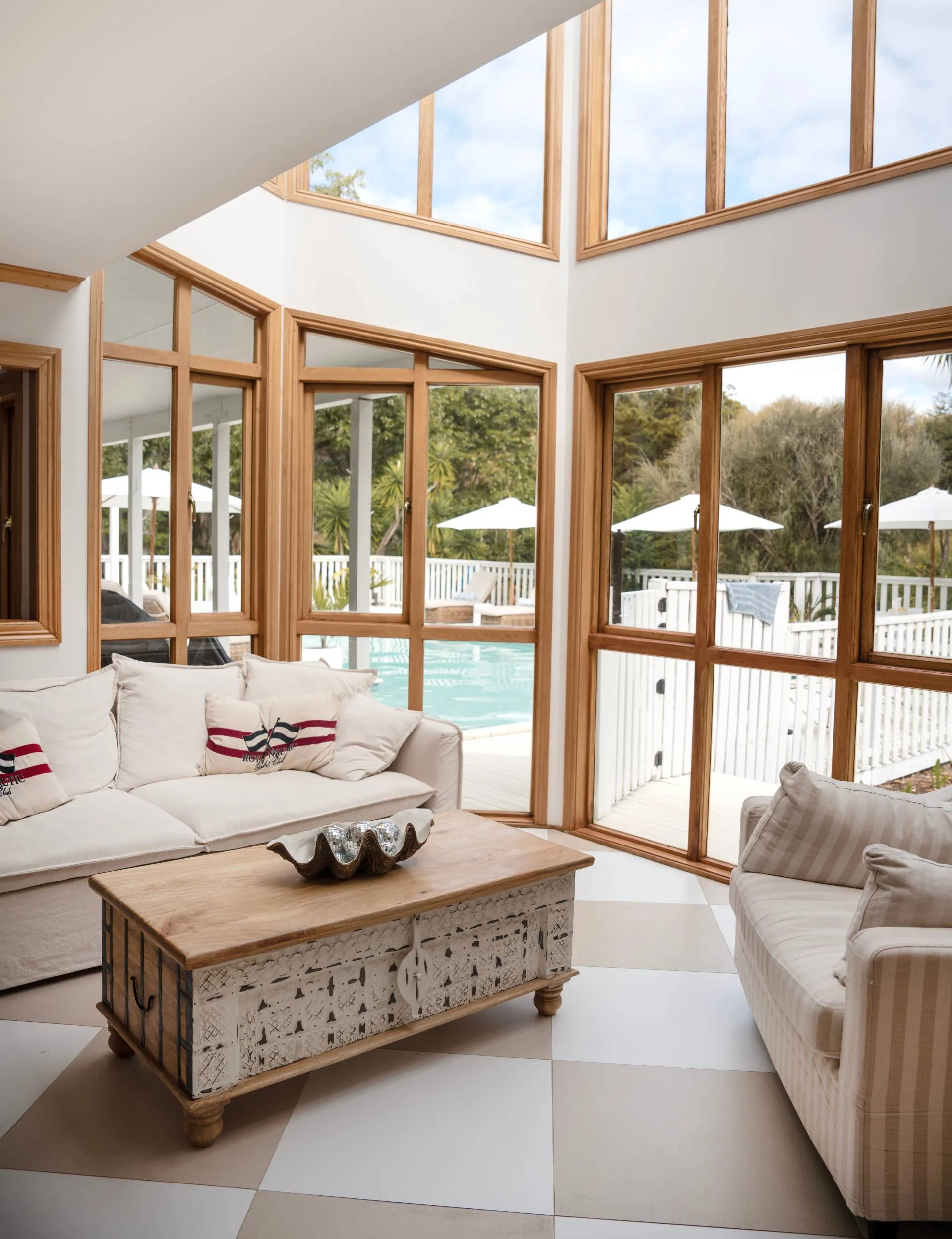 A sunroom in the Auckland homestead overlooking the pool