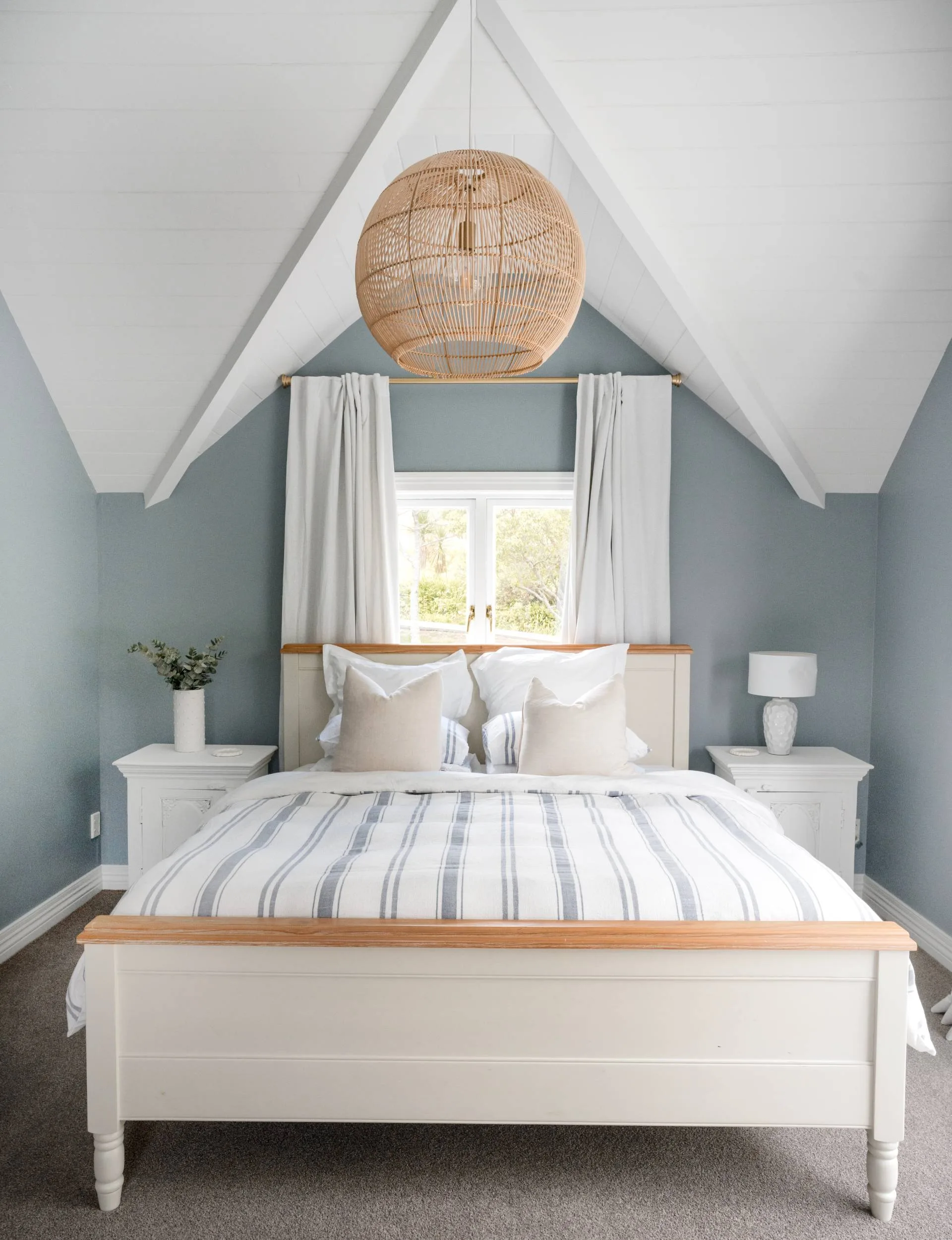 A bedroom with duck egg blue walls