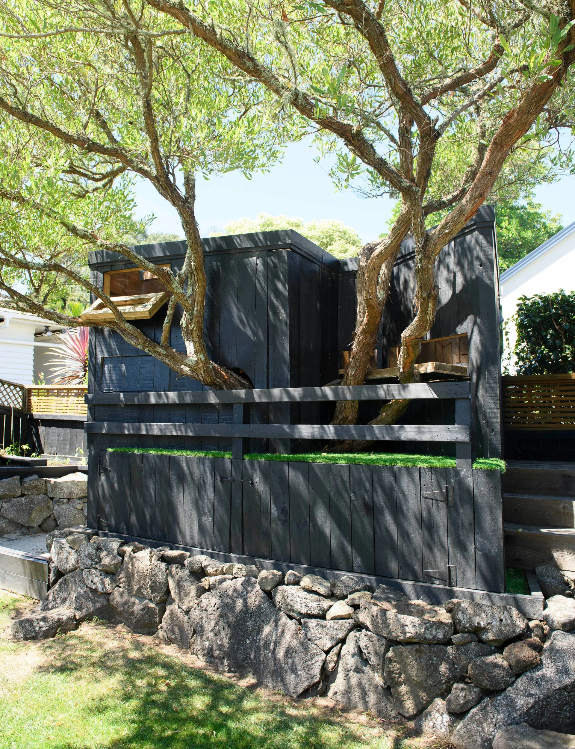 A black treehouse in the back yard of the Epsom art deco&nbsp;home