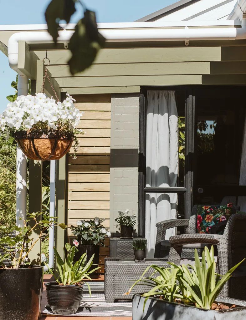 The pergola in this New Plymouth outdoor area has had a refresh with a fresh coat of Resene Hemlock, a potent green colour