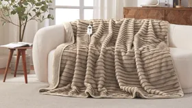 Heated throw blanket on cream couch