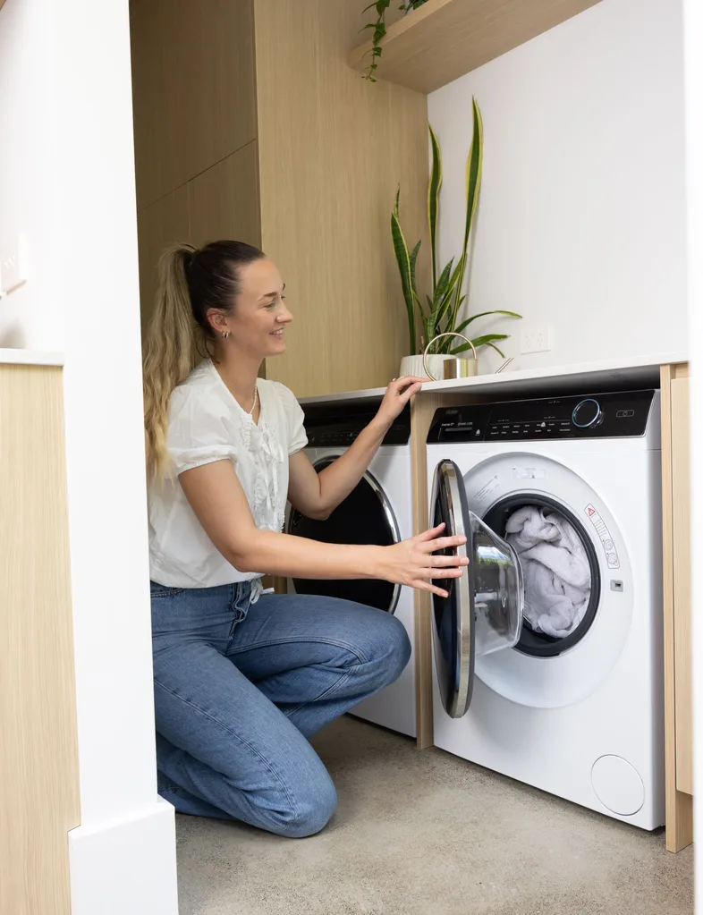 Skye Ross doing laundry with the Haier 10kg Front Load Washer