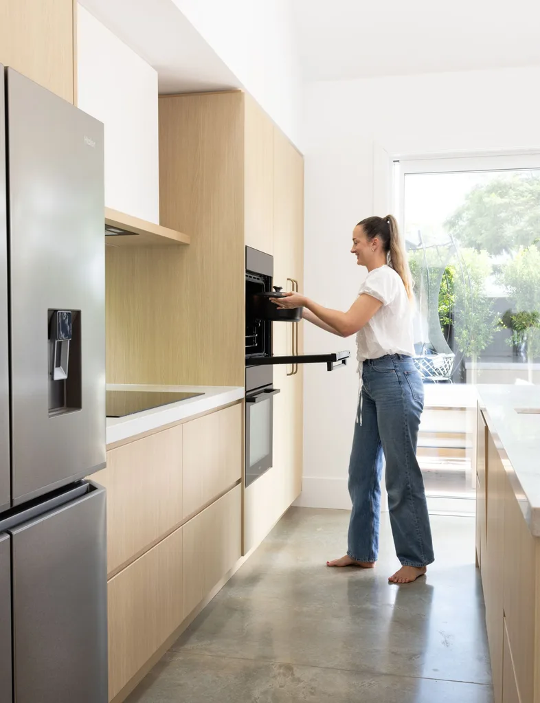 Skye Ross taking dutch oven our of her Haier 60cm Built in Oven