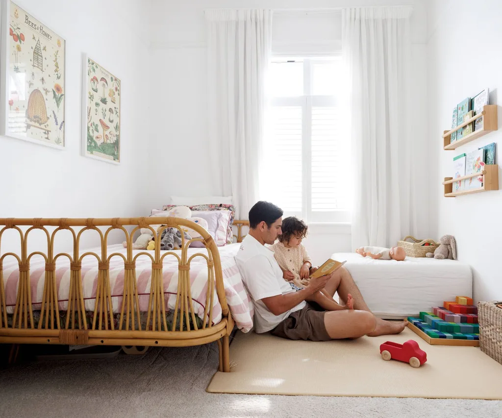 Mark and daughter Tully in the child's bedroom, featuring a cane bed from Freedom